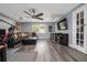 Cozy living room featuring hardwood floors, a plush sectional sofa, and a ceiling fan for optimal comfort at 38 Fairway Cir, New Smyrna Beach, FL 32168