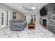 Relaxing living room with ample seating, skylight, and stone fireplace feature wall at 38 Fairway Cir, New Smyrna Beach, FL 32168