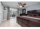 A main bedroom featuring a large bed, ceiling fan, and closet with mirrored doors at 38 Fairway Cir, New Smyrna Beach, FL 32168