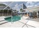 The screened-in pool has ample seating, and a dining area near the pool at 38 Fairway Cir, New Smyrna Beach, FL 32168