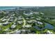 A beautiful aerial view showcasing a neighborhood with mature trees and a tranquil pond, creating a peaceful atmosphere at 3824 Saxon Dr, New Smyrna Beach, FL 32169