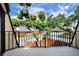 Balcony featuring a metal railing overlooking neighborhood trees and street, perfect for relaxing outdoors at 3824 Saxon Dr, New Smyrna Beach, FL 32169