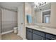 Neutral bathroom with a shower/tub, modern vanity, and stylish tiling, providing a clean, functional space at 3824 Saxon Dr, New Smyrna Beach, FL 32169
