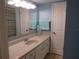 Bathroom with blue walls, tile flooring, and a spacious vanity at 3824 Saxon Dr, New Smyrna Beach, FL 32169