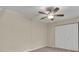 Well-lit bedroom with ceiling fan and closet maximizing space, offering comfort and functionality at 3824 Saxon Dr, New Smyrna Beach, FL 32169