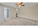 Bright bedroom with ceiling fan, ensuite bathroom and large closet offering practical and comfortable living at 3824 Saxon Dr, New Smyrna Beach, FL 32169