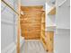 Walk-in closet with built-in wooden shelving and wooden paneling, maximizing storage and organization at 3824 Saxon Dr, New Smyrna Beach, FL 32169