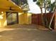 Exterior view of the property featuring a secure side entry and storage closet, with a decorative rock garden at 3824 Saxon Dr, New Smyrna Beach, FL 32169