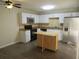 A bright kitchen featuring stainless steel appliances, white cabinets, and a wood rolling island at 3824 Saxon Dr, New Smyrna Beach, FL 32169