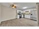 Bright kitchen features white cabinets, stainless steel appliances, and a ceiling fan at 3824 Saxon Dr, New Smyrna Beach, FL 32169