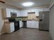 Updated kitchen with stainless steel appliances, white cabinetry and tile backsplash at 3824 Saxon Dr, New Smyrna Beach, FL 32169