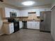 Updated kitchen with stainless steel appliances, white cabinetry and tile backsplash at 3824 Saxon Dr, New Smyrna Beach, FL 32169