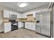 White kitchen features stainless steel appliances and tile backsplash at 3824 Saxon Dr, New Smyrna Beach, FL 32169