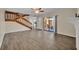 Open-concept living room featuring hardwood floors, stairs, and a patio entrance at 3824 Saxon Dr, New Smyrna Beach, FL 32169