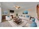 Bright living room with hardwood floors, a decorative fireplace, and stylish furnishings at 3824 Saxon Dr, New Smyrna Beach, FL 32169