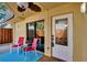 Relaxing patio area with a sliding glass door, white entry door, and comfortable seating at 3824 Saxon Dr, New Smyrna Beach, FL 32169