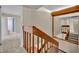View of carpeted stairs with wooden banister, and mirror showing landing area leading into bedrooms at 3824 Saxon Dr, New Smyrna Beach, FL 32169