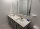 Bright bathroom featuring double sinks set in a gray cabinet and large mirrors at 3919 Willowbrook Dr, Edgewater, FL 32141