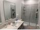 Bright bathroom featuring a walk-in shower with glass doors and a gray vanity at 3919 Willowbrook Dr, Edgewater, FL 32141