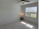 Well-lit bedroom featuring tile flooring, a ceiling fan, and a window overlooking the neighborhood at 3919 Willowbrook Dr, Edgewater, FL 32141