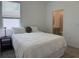 Comfortable bedroom featuring a queen bed, a window with blinds, and an en-suite bathroom at 3919 Willowbrook Dr, Edgewater, FL 32141
