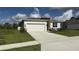 Beautiful one-story home features a well-manicured lawn, a two-car garage, and a welcoming entrance with stone accents at 3919 Willowbrook Dr, Edgewater, FL 32141