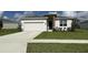 Inviting single-Gathering home featuring a two-car garage, manicured lawn, and stone accents at 3919 Willowbrook Dr, Edgewater, FL 32141