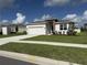 Charming single-story home with a two-car garage, well-manicured lawn, and tidy landscaping at 3919 Willowbrook Dr, Edgewater, FL 32141