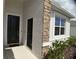 Close-up of the front entrance featuring two black doors and decorative stone accents at 3919 Willowbrook Dr, Edgewater, FL 32141