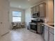 Eat-in kitchen featuring stainless steel appliances, ample natural light, and seating area with table and chairs at 3919 Willowbrook Dr, Edgewater, FL 32141