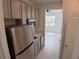 Efficient kitchenette featuring stainless steel appliances and gray cabinets at 3919 Willowbrook Dr, Edgewater, FL 32141
