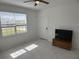 Bright living room featuring tile flooring, a ceiling fan, and a TV on a wooden cabinet at 3919 Willowbrook Dr, Edgewater, FL 32141