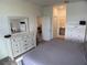 Bright main bedroom featuring a large mirror over a stylish dresser and an ensuite bathroom at 3919 Willowbrook Dr, Edgewater, FL 32141