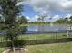 Picturesque view of a pond with a fountain, framed by a black iron fence and lush greenery at 3919 Willowbrook Dr, Edgewater, FL 32141