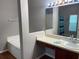 Bright bathroom featuring a vanity with a sink and a soaking tub with tile surround at 405 Central Mariners Dr, Edgewater, FL 32141