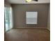 Bedroom with carpet flooring, neutral walls, and sliding glass doors to the pool area at 405 Central Mariners Dr, Edgewater, FL 32141
