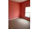 Bedroom with carpet, a window, and a cheerful painted coral wall at 405 Central Mariners Dr, Edgewater, FL 32141