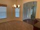 Cozy dining area with a chandelier fixture, carpet and multiple windows for natural light and outside views at 405 Central Mariners Dr, Edgewater, FL 32141
