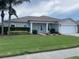Charming single-story home features a well-maintained lawn and inviting front porch with classic column detailing at 405 Central Mariners Dr, Edgewater, FL 32141