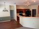 Inviting kitchen with wood cabinets, modern appliances, and breakfast bar seamlessly connected to dining and living areas at 405 Central Mariners Dr, Edgewater, FL 32141