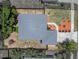 A top-down aerial view shows a well-maintained backyard with seating, along with a house with gray shingles at 411 Ryans Ridge Ave, Eustis, FL 32726