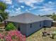 Aerial view of the backyard with patio, lawn, fire pit, and colorful foliage at 411 Ryans Ridge Ave, Eustis, FL 32726