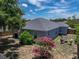 Aerial shot of the backyard showcasing the patio, lawn, and landscaping at 411 Ryans Ridge Ave, Eustis, FL 32726