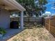 Spacious backyard with a covered patio, fenced yard, and mature trees at 411 Ryans Ridge Ave, Eustis, FL 32726