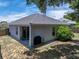 Aerial shot of backyard with covered patio, grill, and mature landscaping at 411 Ryans Ridge Ave, Eustis, FL 32726