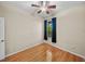 Cozy bedroom features a ceiling fan, a window, and hardwood flooring at 411 Ryans Ridge Ave, Eustis, FL 32726