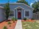 Charming home features manicured landscaping, decorative front door wreath, and two windows inviting natural light at 411 Ryans Ridge Ave, Eustis, FL 32726