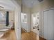 Hallway features doors to the bedroom, bathroom, laundry room and a closet with wood-look flooring at 411 Ryans Ridge Ave, Eustis, FL 32726