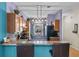 Stylish kitchen featuring a breakfast bar, modern lighting, and stainless steel refrigerator at 411 Ryans Ridge Ave, Eustis, FL 32726