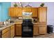 Functional kitchen with ample counter space, wooden cabinets, and modern black appliances at 411 Ryans Ridge Ave, Eustis, FL 32726